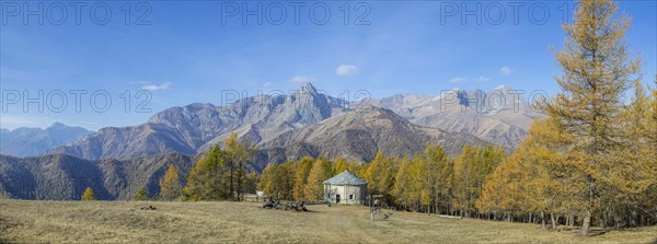 View of Monte Cersogno and Pelvo di Elva in autumn with chapel Chiesa San Giovanni