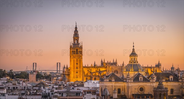 View of La Giralda and Iglesia del Salvador at sunset