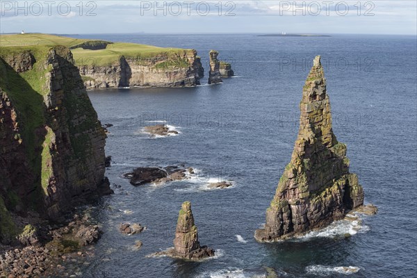 Rugged coastal landscape with the rock spikes Duncansby Stacks