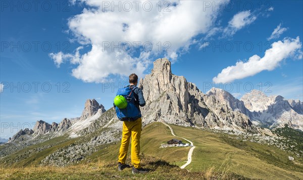 Hiker looking down to Passo Giau