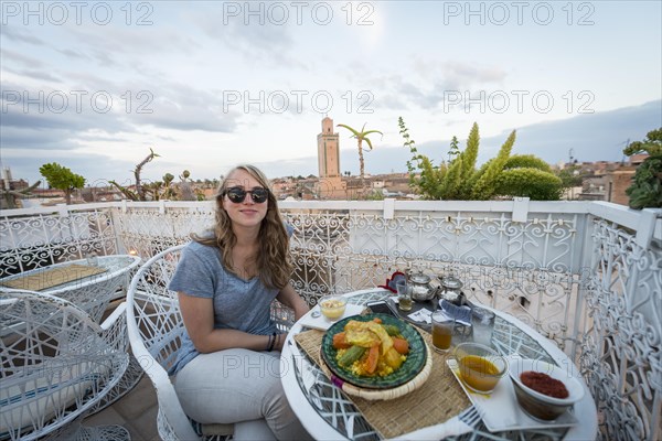 Young woman on a roof terrace in the restaurant