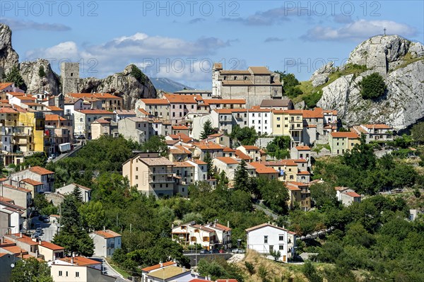 View of mountain village Pietrabbondante with medieval tower and church Chiesa di Santa Maria Assunta on rock Morg Caraceni