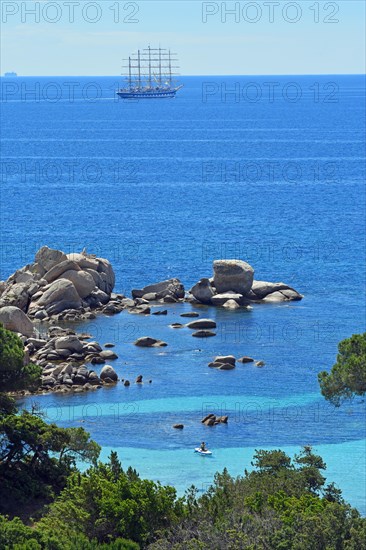 Palombaggia beach with turquoise blue sea and sailing ship