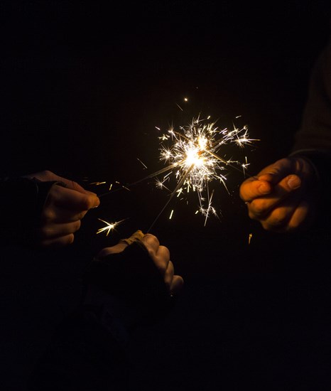 Burning sparklers in hands