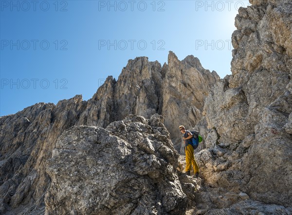Hiker at the Pas de le Coronele near the Rosengarten group