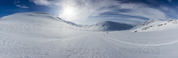 Ski tourer with pulka in the snow