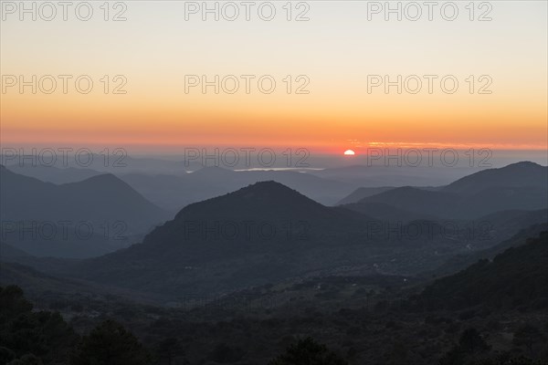 Wooded mountain landscape at sunset