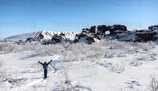 Man on hiking trail in the snow in sunshine