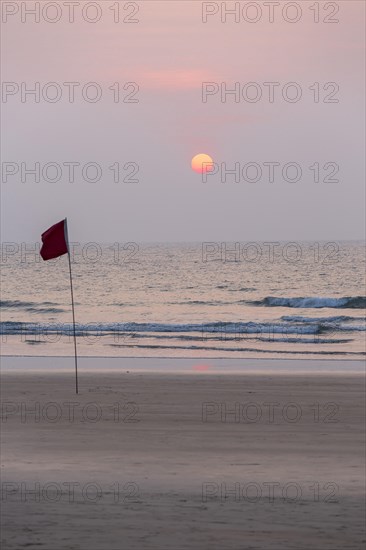 Lifeguard flag in sunset at Agonda Beach