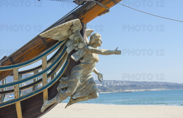 Sailing ship with angel as figurehead on beach