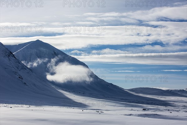 Cloud between mountains in the snow