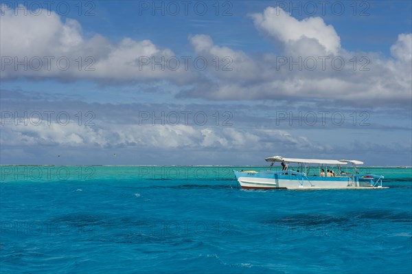 Tourist boat in the turquoise lagoon of Bora Bora