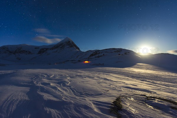 Full moon with tent in the snow