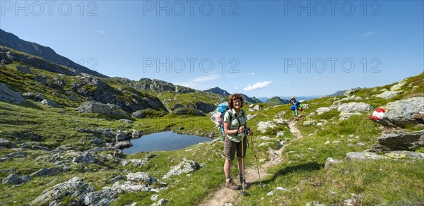 Two hikers at a small lake