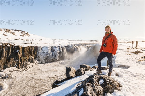 Man with camera standing at the edge