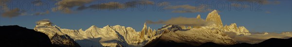 Snow-covered mountain range with Cerro Torre and Fitz Roy at sunrise