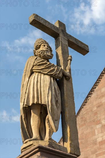 Statue on top of Emperor Constantin Fountain in front of Sainte Croix church in Kaysersberg