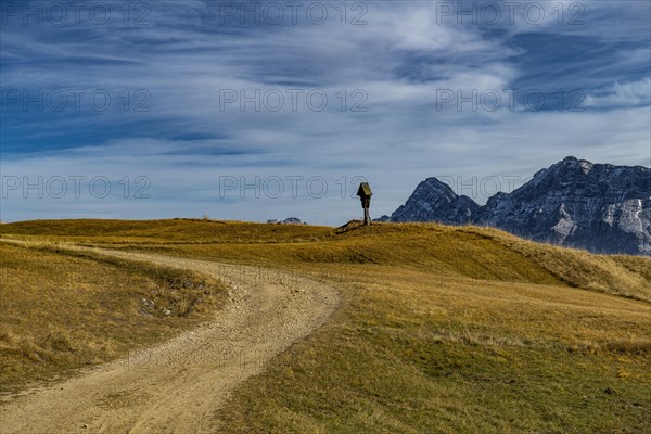 Trail with memorial cross and South Tyrolean mountains