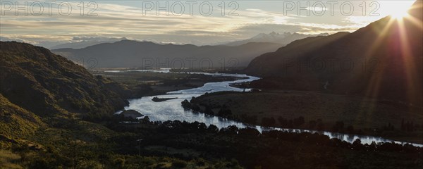 Glacier river Rio Baker at sunset with the mountains of the Andes behind