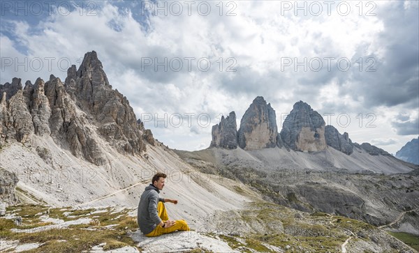 Hiker sits on rock