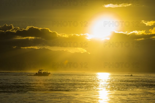 Sihouette of a little boat at sunset