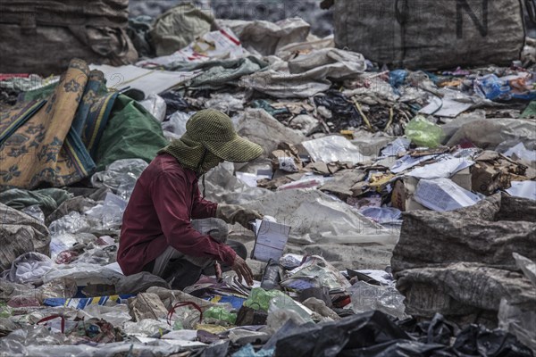 Garbage collectors on rubbish dump on the outskirts