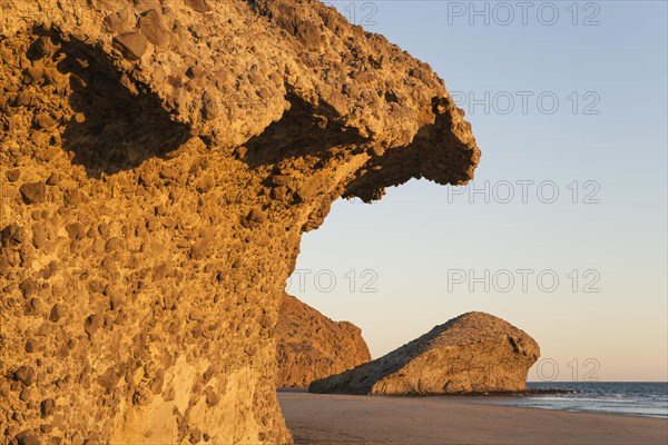 Fossilized lava tongues and walls at the beach Playa del Monsul