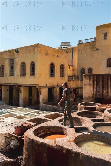 Worker dyeing leather