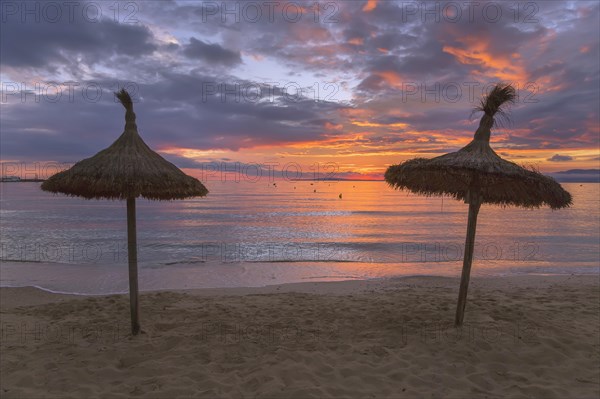 Thatched sun shade umbrellas at s'Arenal beach