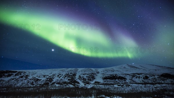 Northern Lights (Aurora borealis) over mountains