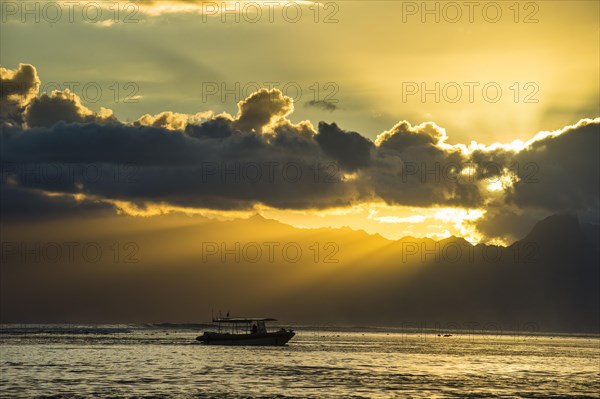 Silhouette of a little boat at sunset