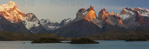 Glowing mountain massif Cuernos del Paine at sunrise