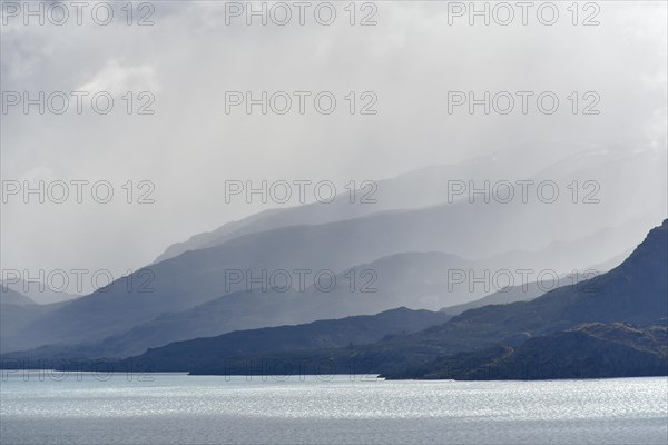 Clouds overhanging mountains at Lake Lago General Carrera (or also Lago Buenos Aires in Argentina)