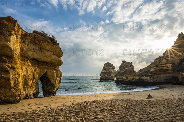 Rocky coast with beach and red rocks