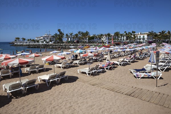 Sandy beach with sun loungers and beach umbrellas