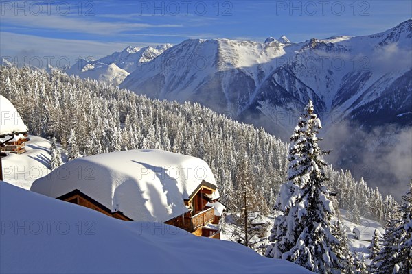 Winter landscape with snow-covered chalet