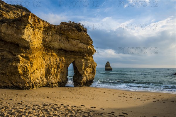 Rocky coast with beach and red rocks