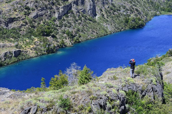 Tourist with binoculars at Lago Cochrane