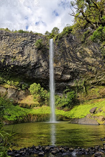 Wall of columnar basalt with waterfall Bridal Veil Falls