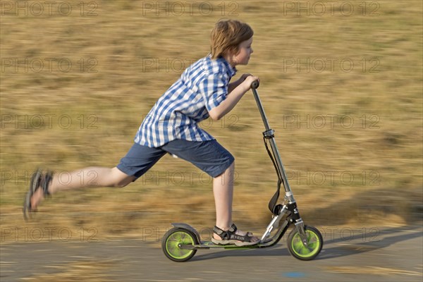 Boy is riding scooter