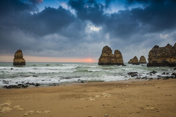 Rocky coast with beach and red rocks