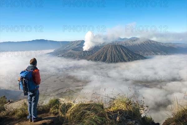 Young man in front of volcanic landscape