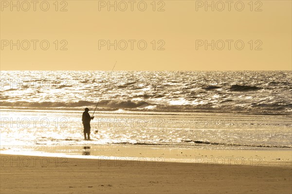 Fisher on the beach of the North Sea