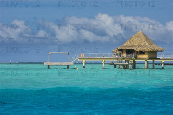 Overwater bungalows on stilts in luxury hotel