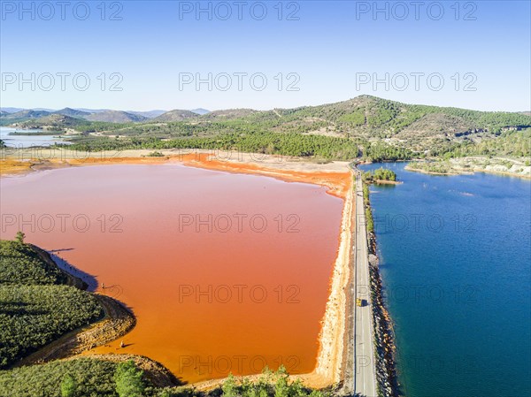 Street trough orange and blue lakes in mining region