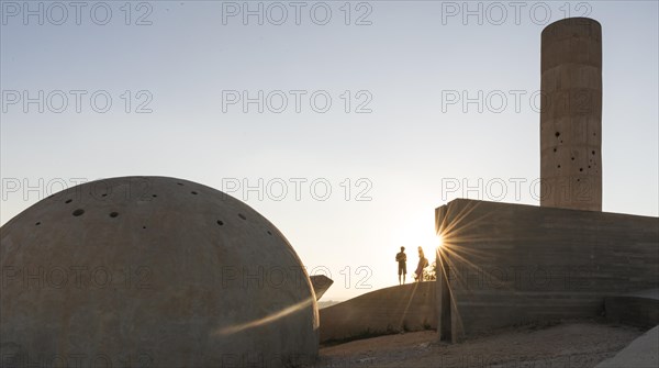 Two people standing at the concrete monument