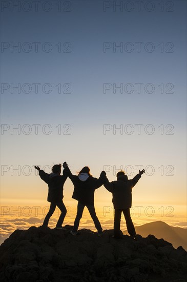 Tourists in backlight waiting for sunset on top of Haleakala National Park