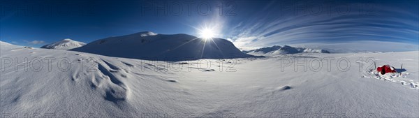 Tent with sun in the snow