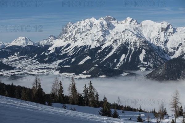 View from the Hauser Kaibling ski mountain to the Dachstein massif with the Enns valley in the fog