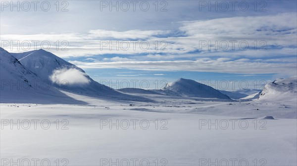 Cloud between mountains in the snow